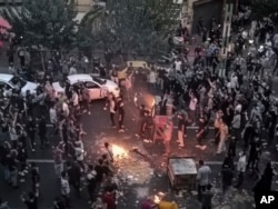 Iranians protest Mahsa Amini's death after she was detained by the morality police in Tehran in September 2022.