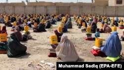 Afghans receiving ration aid in Kandahar last month. 