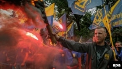 Azov Battalion members and supporters from various right-wing movements burn flares during a rally in front of parliament in Kyiv in May 2016.