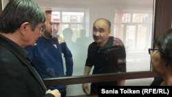 Kazakh activists Maks Boqaev (2nd right) and Talgat Ayan (2nd left) appear in court in Atyrau on November 18.