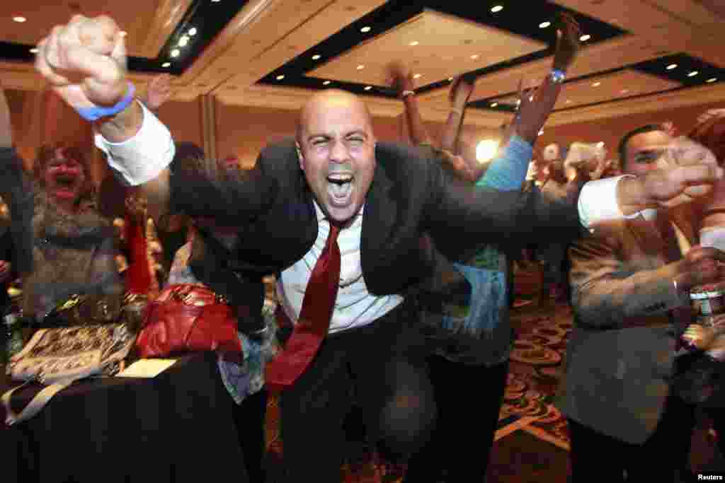 Obama supporter Ajay Narayan cheers during a Democratic election-night party at the Mandalay Bay Resort in Las Vegas, Nevada as a TV network announces results.