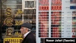 A man walks past a currency exchange shop in Tehran's business district on January 21, 2018.