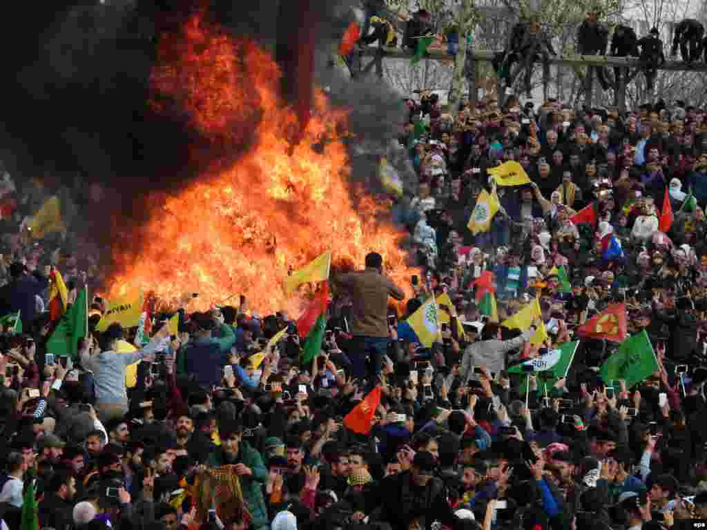 Crowds around a bonfire during the celebrations in Diyarbakir, Turkey, on March 21.&nbsp;