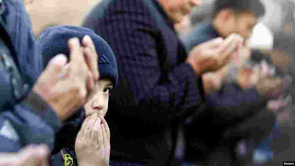 A boy looks on during Kurban-Ait (Eid al-Adha in Arabic) prayers in front of Central Mosque in Almaty, Kazakhstan, on October 26. (Reuters/Shamil Zhumatov)