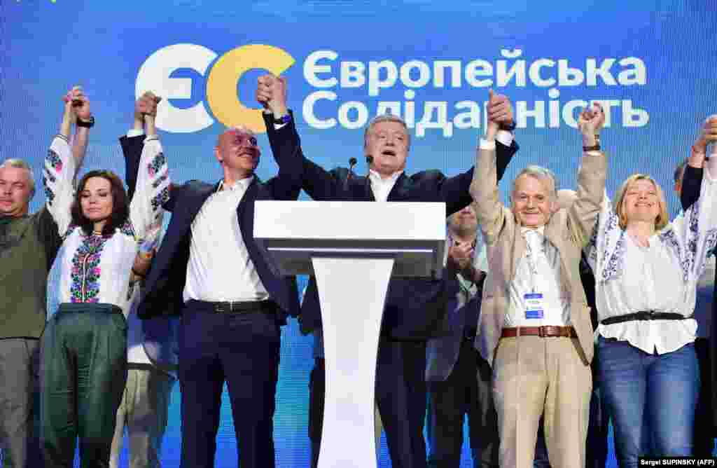 Former Ukrainian President Petro Poroshenko greets supporters at the headquarters of European Solidarity. Exit polls predict that Poroshenko&#39;s party is set to get 8.9 percent of the votes. (AFP/Sergei Supinsky)