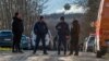 Hungarian police officers close the road near the crash site where a vehicle taking part in the Esztergom Nyerges Rally veered off the road on March 24. 