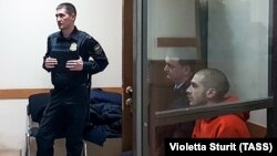 Rap singer Dmitry Kuznetsov (right), known as Husky, appears in court on November 22.