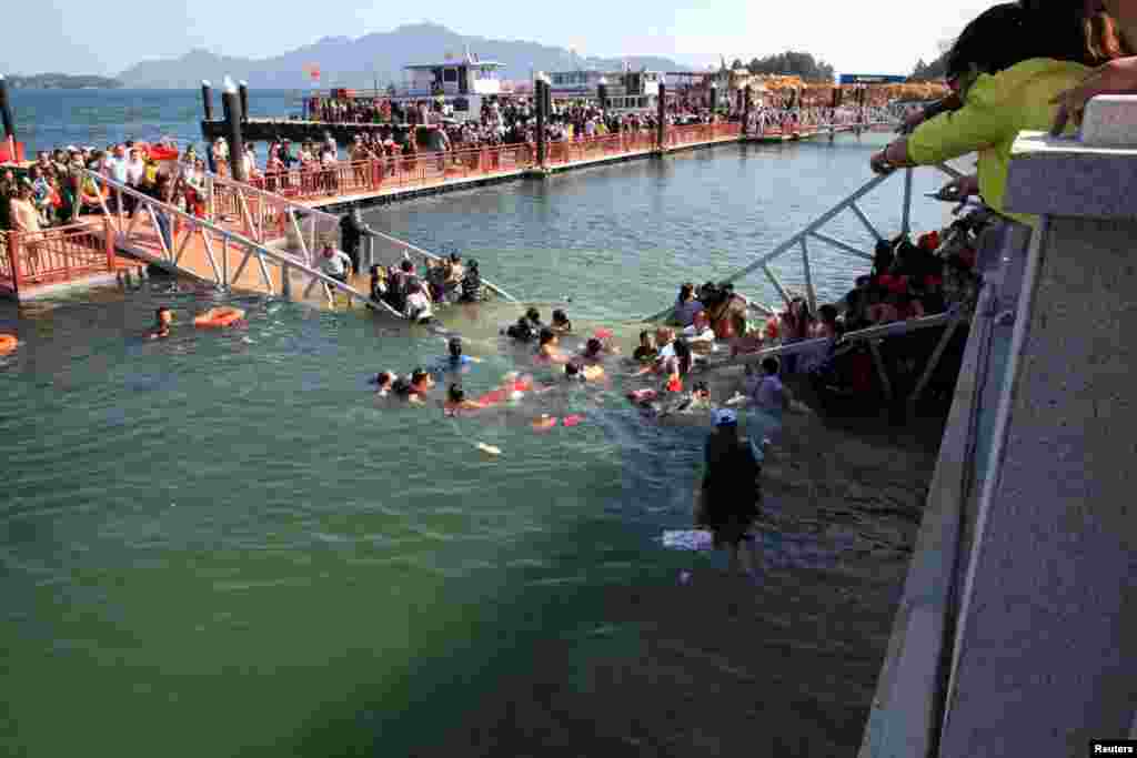 A bridge collapses at Lushan Mountain in Jiangxi province, sending tourists hurtling into the water. Chinese media reported that no one was seriously injured. (Reuters)