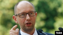 Ukrainian Prime Minister Arseny Yatsenyuk talks to reporters in Kyiv on August 8 about sanctions proposed by the Cabinet against "individuals and legal entities financing terrorism and supporting the occupation of Crimea."