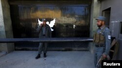 Afghanistan -- Afghan police guard the gate of a guest house after an attack in Kabul May 14, 2015. 