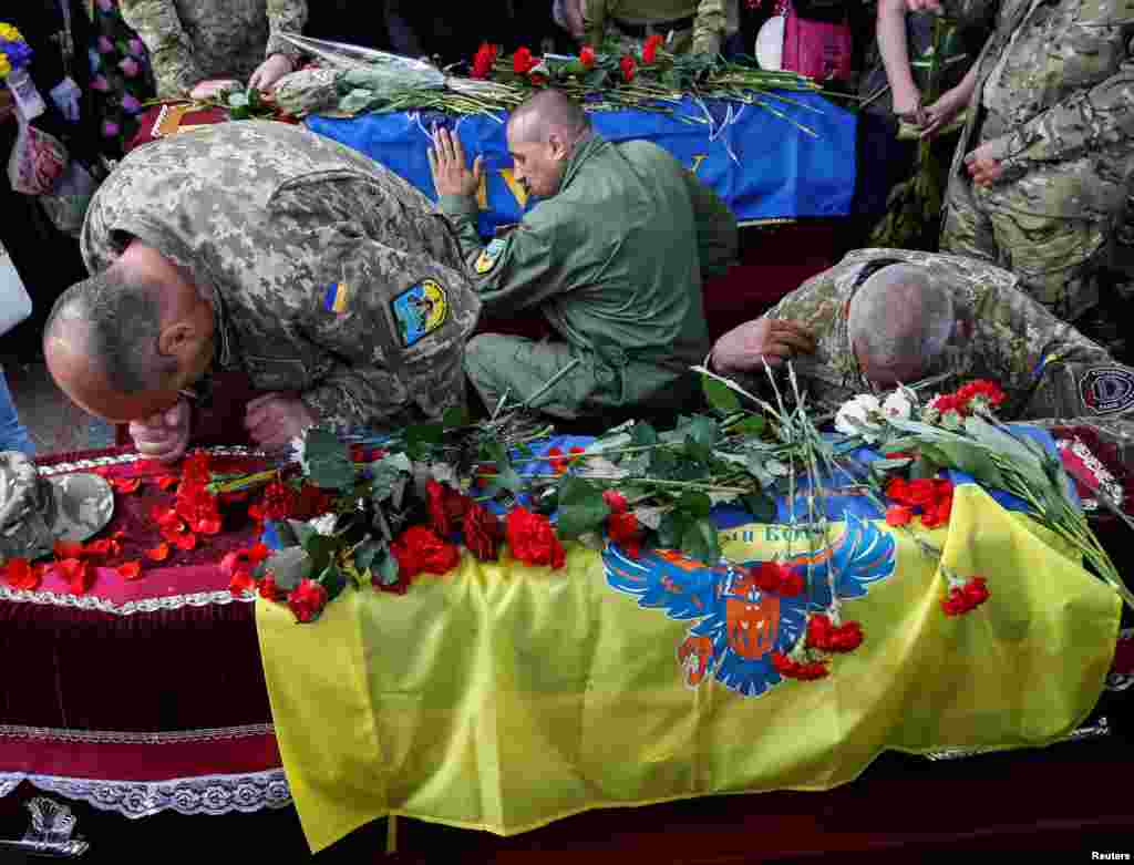 Fighters take part in a funeral ceremony for Mykola Kuliba and Serhiy Baula, from the volunteer Aydar battalion, who were killed in fighting in eastern Ukraine, on Independence Square in central Kyiv. The battalion has been accused of committing war crimes by Amnesty International. (Reuters/Gleb Garanich)