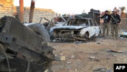 Members of the Iraqi security forces point at destruction in the rural Husayba al-Sharkiya area, east of the Anbar Province capital of Ramadi, as they undertake military operations to attack Islamic State (IS) group positions on December 20.