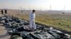 A forensic investigator works at the scene of a Ukrainian plane crash as bodies of the victims are collected, in Shahedshahr, southwest of the capital Tehran, January 8, 2020