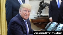 File - U.S. President Donald Trump speaks while participating in a border funding legislation signing ceremony in the Oval Office of the White House in Washington, U.S. July 1, 2019