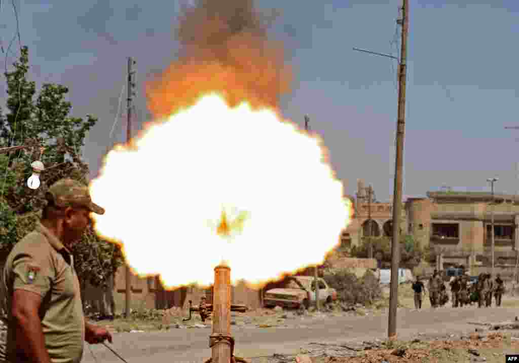 Members of the Iraqi forces fire mortar shells during battles in western Mosul's Zanjili neighbourhood, as government forces advance in the area during their ongoing battle against Islamic State (IS) group fighters on May 31. (AFP/Karim Sahib)