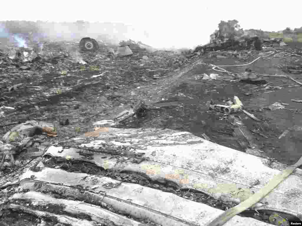 Part of the jetliner&#39;s engine is visible amid the wreckage.