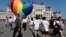 Activists walk past a large rainbow-colored heart erected in front of the country's parliament in Budapest on July 8. The activists were protesting against the recently passed law they say discriminates and marginalizes LGBT people.
