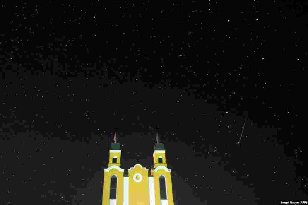 A meteor streaks across the sky behind a Catholic church during the annual Geminid meteor shower in the village of Krevo, some 100 kilometers northwest of Minsk. (AFP/Sergei Gapon)