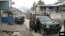 FILE: Army officials stand guard near the site of a suicide bomb blast targeting members of an anti-Taliban militia in Upper Dir.