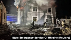 Firefighters work at the site of a Russian drone strike in the Kyiv region on January 30.