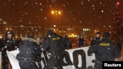 Belarusian police disperse a group of opposition protesters in central Minsk on December 20.