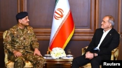 Iranian President Masud Pezeshkian (right) meets with Pakistani army chief, Field Marshal Asim Munir, in Tehran during an April visit. 
