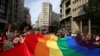 Serbia -- Participants hold a rainbow flag during an annual LGBT (Lesbian, Gay, Bisexual and Transgender) pride parade in Belgrade, September 18, 2016