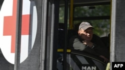 A man sits aboard an evacuation bus before its departure from the city of Pokrovsk on September 20.