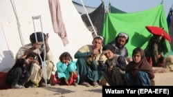 Families who fled their villages after the Taliban launched massive attacks in different districts of Helmand Province live in temporary shelters in the provincial capital of Lashkar Gah on November 24.