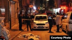 The body of Umarali Quvatov, covered with newspapers, on a street in Istanbul after he was shot and killed