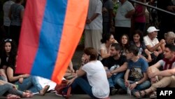 Armenia -- Demonstrators sit on a street during a protest against an increase of electricity prices in Yerevan, June 26, 2015