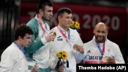 JAPAN - Silver medal winner Richard Torrez Jr., from the United States, left, Gold medal winner Uzbekistan's Bakhodir Jalalov, second from left, bronze medalists Kazakhstan's Kamshybek Kunkabayev, third from left, and Britain's Frazer Clarke, right, durin