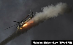 A Russian helicopter launches missiles during a joint training exercise in Russia as part of the Shanghai Cooperation Organization in September. More than 3,000 soldiers from Russia, India, China, Pakistan, Tajikistan, Uzbekistan, Kazakhstan, and Kyrgyzstan were involved.
