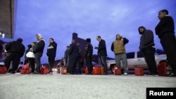 People wait for gas at a Hess fueling station in Brooklyn on November 2.