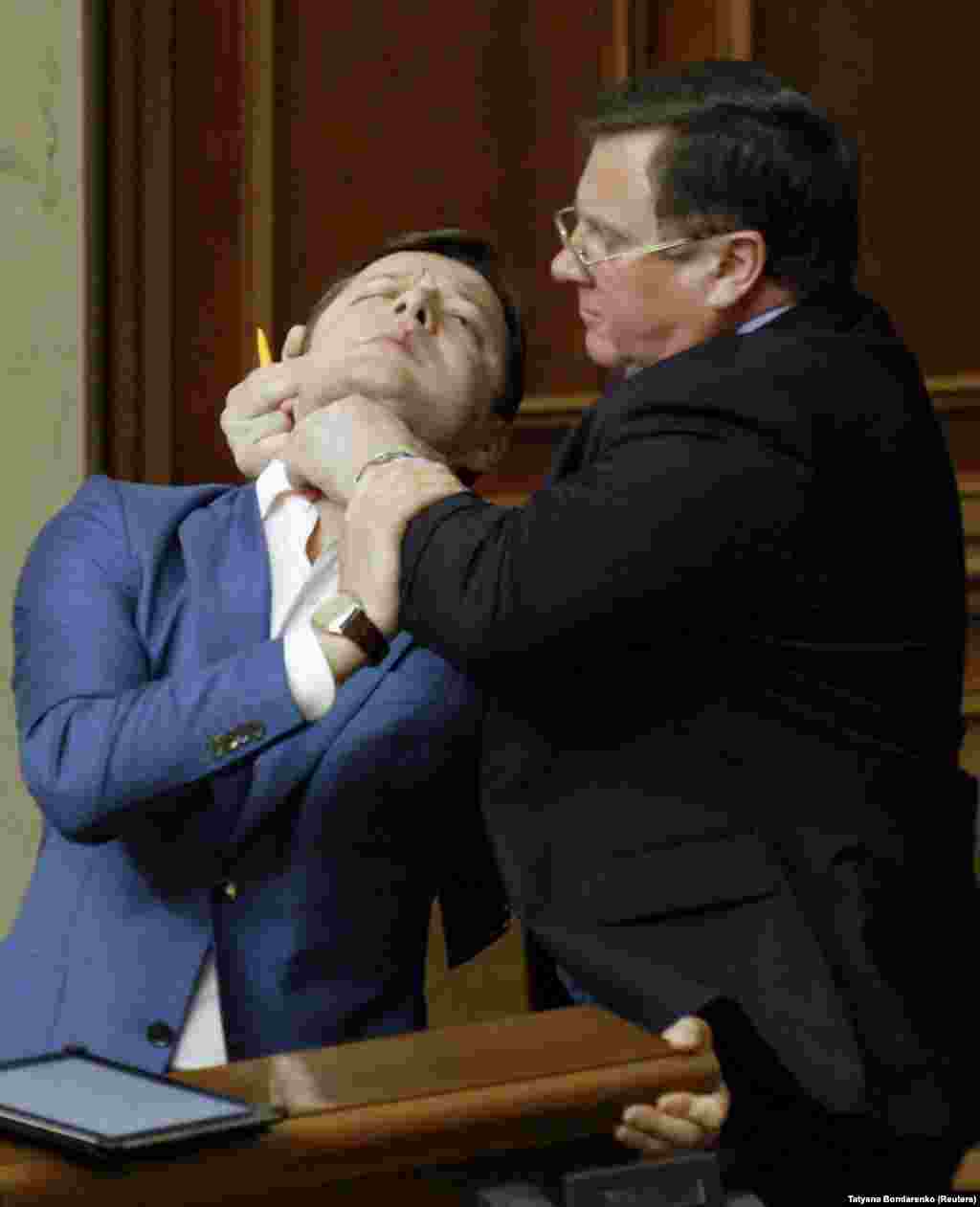 Communist politician Adam Martynyuk (right) holds Oleh Lyashko in a leftist death-grip in May 2011.&nbsp;