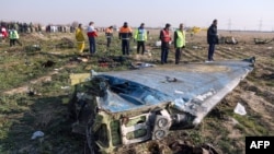 Emergency crews survey the scene of a Ukrainian jetliner shot down by an Iranian missile near Tehran.