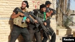 Members of Iraqi security forces conduct a patrol looking for Islamic State (IS) militants in Ramadi earlier this year. IS has made a concerted push to take the city in recent weeks.