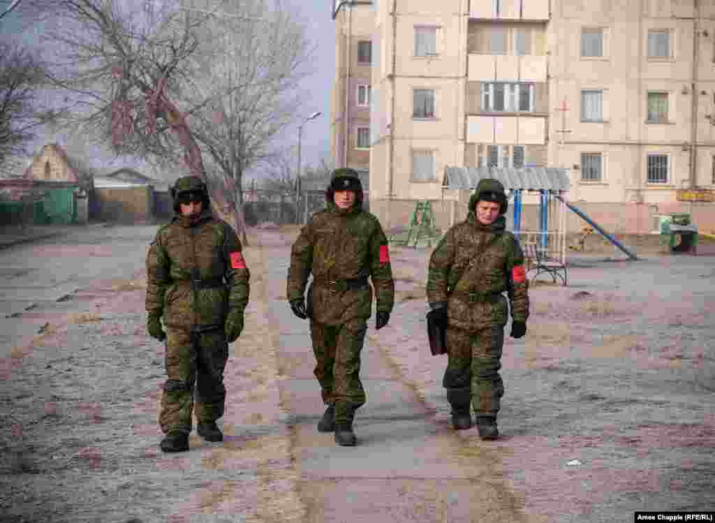 Russian soldiers patrol an area where Russian servicemen and their families are housed.