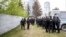 RUSSIA -- Police officers stand in front of a fence to block demonstrators protesting plans to construct a cathedral in a park in Yekaterinburg, May 16, 2019