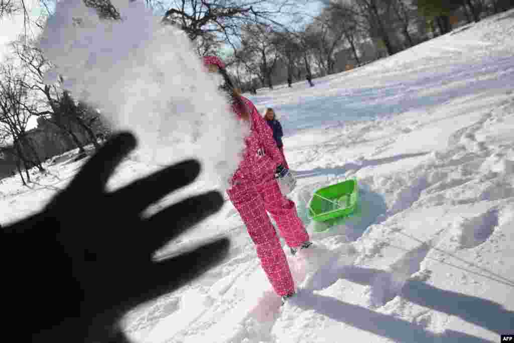 Children throw snowballs in New York&#39;s Central Park on January 3, after a winter storm called &quot;Hercules&quot; struck the Northeast.