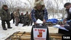 A local man casts his ballot in a portable ballot box during a vote in hard-to-reach areas of Kamchatka on February 20.