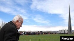 An elderly man carries flowers to the genocide memorial in Yerevan on April 24.