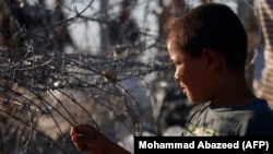 A displaced Syrian boy from Daraa Province fleeing shelling by pro-government forces is seen in a makeshift camp near the Jordanian border on July 2.