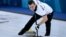 Russia's Aleksandr Krushelnitsky brushes the ice during the curling mixed doubles during the Winter Olympic Games on February 8.