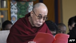 The Dalai Lama reads a statement from the Tibetan parliament-in-exile during a ceremony marking the 52nd anniversary of the 1959 Tibetan uprising in Dharamshala today.