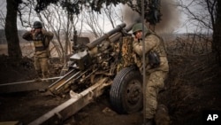 Українські військові ведуть вогонь по російських позиціях поблизу Авдіївки Донецької області, 22 березня 2024 року
