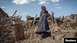 Iran -- An earthquake victim stands near damaged houses in the earthquake-stricken town of Azerbaijan, 13Aug2012