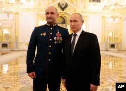 Vladimir Putin (right) poses with Ukrainian separatist leader Artyom Zhoga at the Kremlin on December 8.