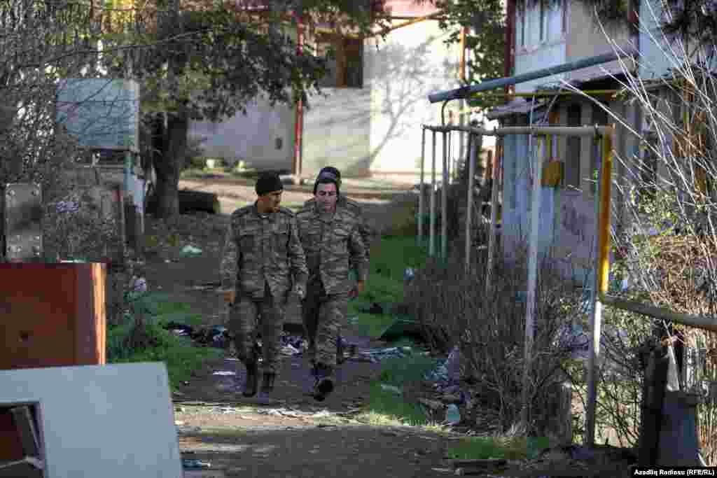 Azerbaijani troops pass a house in Hadrut on November 25.