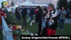 Mourners leave flowers at a makeshift memorial near School No. 175.